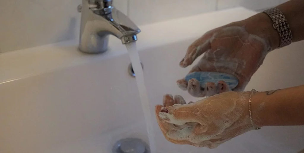 Mulher lavando as mãos com sabonete